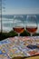 Tasting of sweet moscatel de setubal or porto portuguese wine and view on blue Atlantic ocean near Sintra in Lisbon area, Portugal