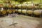 Tasting table with many glasses against rows of tuns