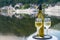 Tasting of white quality riesling wine served on outdoor terrace in Mosel wine region with Mosel river and old German town on