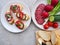 Tasty appetizers with cream cheese, salami and vegetables