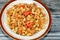 tasty appetizing classic ring pasta macaroni with tomato sauce and pieces, garlic, onion, spices, oil and black and green pepper,