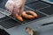 Tasty and appetizing sausages are grilled on a BBQ grid