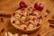 Tasty apple pie with fresh red cranberries and walnuts decorated with two apples, ginger and cinnamon. Just backed apple pie