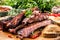 Tasty barbecue grilled pork ribs with chili pepers and parsley h