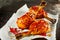 Tasty barbecued chicken legs with hot chili sauce