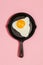 Tasty beautiful food fried egg in pan on fashionable pink background. Minimalistic Concept. Top View.