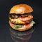 Tasty big burger with cutlet meat and tomato on a mirror black background