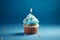 Tasty birthday cupcake with a candle on a blue background. Mini cake. Ai generative