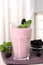 Tasty blackberry milk shake with berries on table