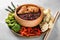 Tasty boiled wild rice with meat in bowl and vegetables on plate