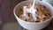 Tasty breakfast - milk is poured into a bowl with cornflakes and chocolate chips