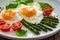 Tasty breakfast. Sunny side up eggs with cooked green asparagus and fried tomatoes served on wooden table