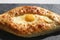 Tasty bright macro photo of Adzhar-style khachapuri