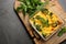 Tasty broccoli casserole in baking dish on grey table