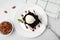 Tasty brownies served with ice cream and caramel sauce on white tiled table, flat lay