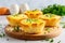 A tasty brunch with egg, muffin cups with bacon, cheese, and fresh greens