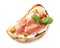 Tasty bruschetta with prosciutto and mustard on white background