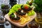 Tasty bruschetta with tapenade on wooden table