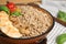 Tasty buckwheat porridge with meat and mushrooms in bowl