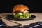 Tasty burger served on a black plate placed on a marble desk.