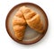 Tasty buttery croissants on plate.