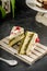 Tasty cake with pistachio and strowberry on the wooden pallet. Sweet homemade wiped cream.