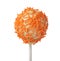 Tasty cake pop with orange sprinkles on white