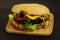 Tasty cheeseburger on wooden board