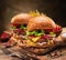 Tasty cheeseburgers and french fries on wooden tray