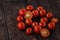 tasty cherry tomatoes on a wooden stand, wooden background