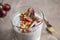 Tasty chia seed pudding with granola and grape on table