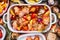 Tasty chicken with colorful vegetables and red sweet paprika in casserole, preparation on rustic wooden background with bowls and