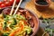 Tasty chinese noodles, meat and vegetables on plate, closeup