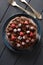 Tasty chocolate cake with chocolate icing and raw berries with vintage forks on dark background