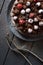 Tasty chocolate cake with chocolate icing and raw berries with vintage forks on dark background