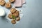 Tasty chocolate chip cookies, glass of milk and mint leaves on light grey table, flat lay. Space for text