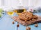 Tasty chocolate chip cookies stacked on a board served with tea and teapot on blue wooden table.Organic homemade snacks for