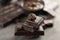 Tasty chocolate and coffee bean on table, closeup