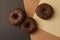 Tasty chocolate donuts on three tone background