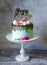 Tasty chocolate drip cake decorated with zephyr and flowers