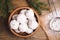 Tasty Christmas snowball cookies in bowl on wooden table, flat lay