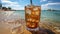 Tasty Cola in a glass with ice cubes on the beach near the sea or ocean, menu concept