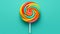 Tasty coloreful lollipop on turquoise background, top view