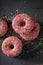 Tasty and colorful pink donuts topped with sprinkles