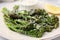 Tasty cooked broccolini with cheese on plate, closeup