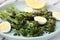 Tasty cooked broccolini with cheese and quail eggs on plate, closeup