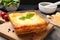 Tasty cooked lasagna in baking dish on grey table, closeup