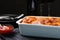 Tasty cooked lasagna in baking dish on table, closeup