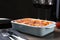 Tasty cooked lasagna in baking dish on wooden table