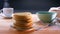 Tasty cooked pancakes on the table with steaming hot drink and honey on a table